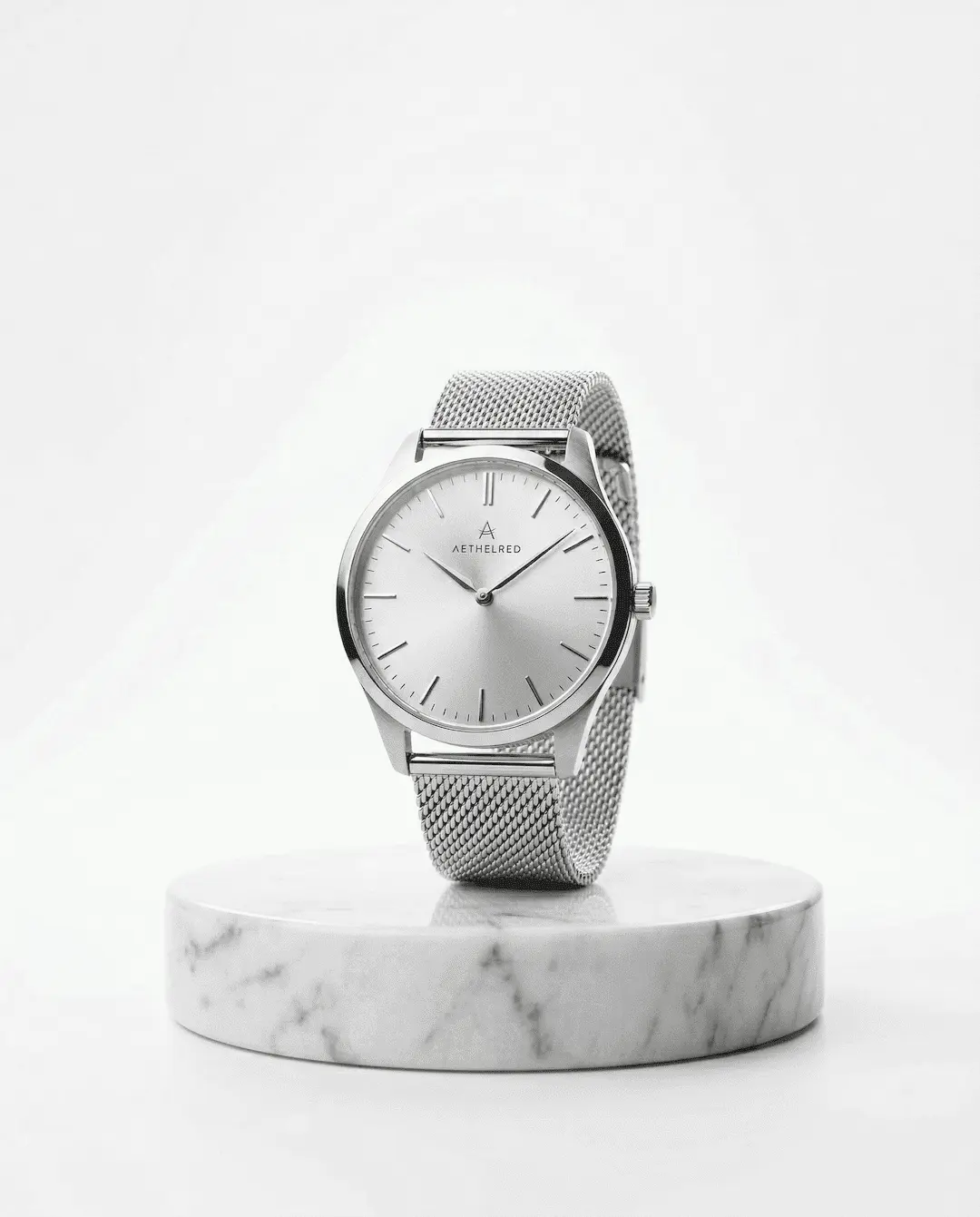 "A single elegant, minimalist silver wristwatch displayed on a smooth white marble pedestal. High-key studio lighting, pure white background, soft reflections, pristine and luxurious"